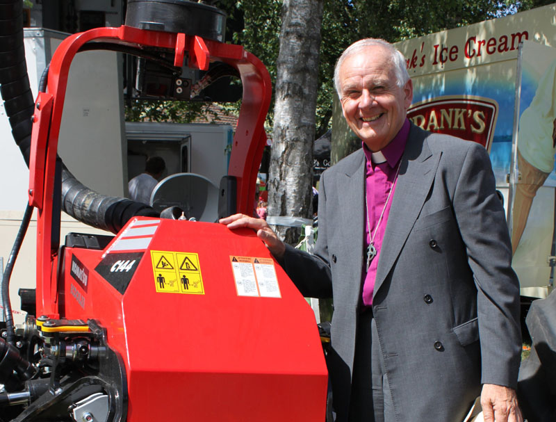 Archbishop Barry Morgan at the Royal Welsh Show looking at a tree harvesting machine