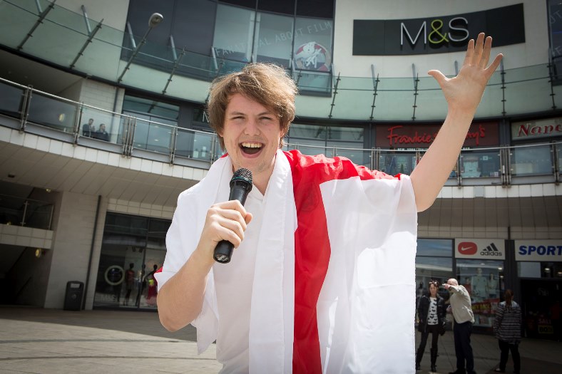 Eagles Meadow, Wrexham.  Capital Radio 1 DJ Ben Sheppard sings English national anthem for a bet as they beat Wales in the Euro's. Pictured: Ben singing