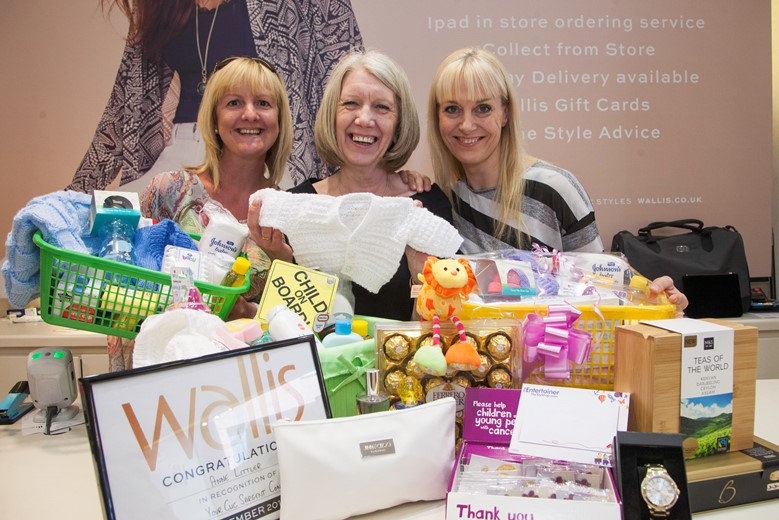 Eagles Meadow....  Pictured are Lisa Jones, Wallis  Manager Ann Littler  and Lisa Varelo Pinto with some of the  prizes in the grand raffle they're doing in June in aid of CLIC Sargent children's cancer charity.