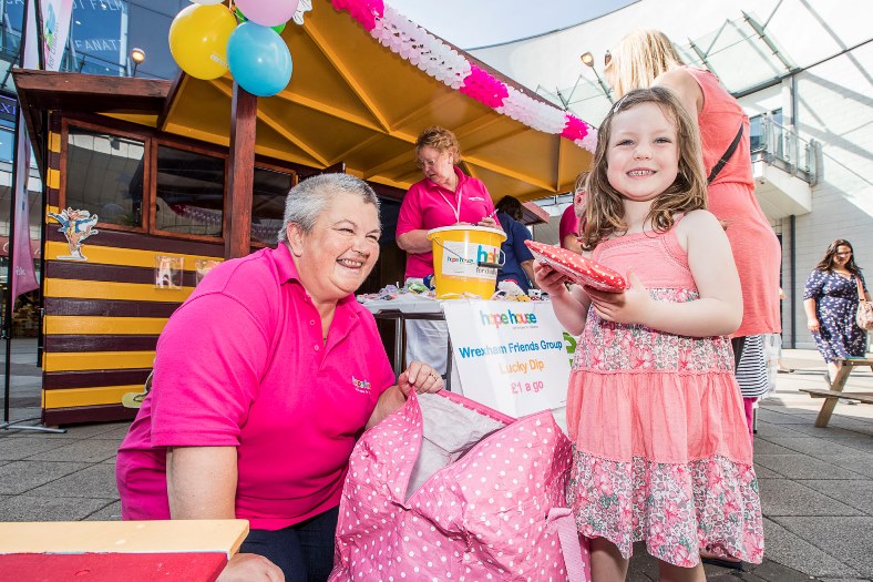 Wrexham Friends of Hope House children's hospice have held a special holiday event in the Roald Dahl story shack in Eagles Meadow in Wrexham. Karen Price form Wrexham Friends of Hope House helps four years old Megan Evans from Penycae select her lucky dip