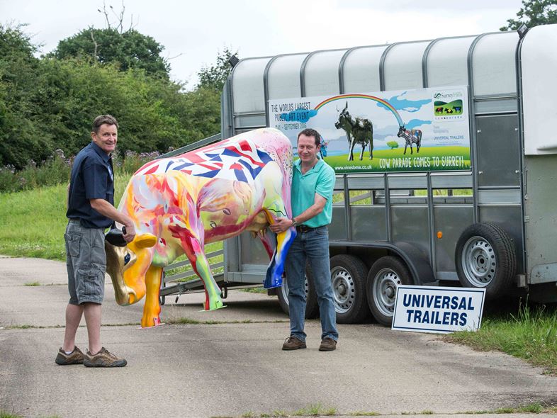 CowParade Surrey. Tim Metson with Mark Betts (in dark blue shirt) of Universal Trailers, Billingshurst. Photo: Dave Hill 15/07/2016