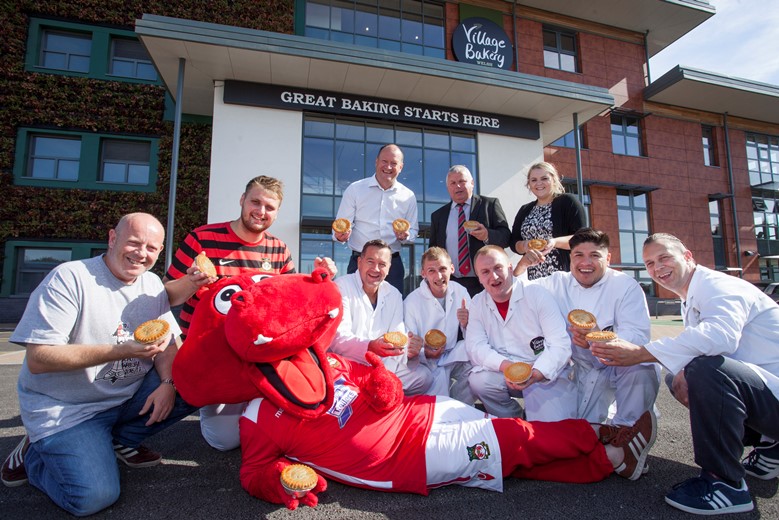 VILLAGE BAKERY WREXHAM AND WFC... Pictured with Wrex the Dragon are Stuart Roberts, Wrexham supporters trust with Village Bakery staff Craig Herling, Martyn Baker Hughes, John Jones, Anthony Dougherty, Daniel Garcia, and Ianin Lake, Village Bakery Managing Director Robin Jones, Geoff Scott WFC commercial Manger and Catherine Bletcher from Village Bakery .