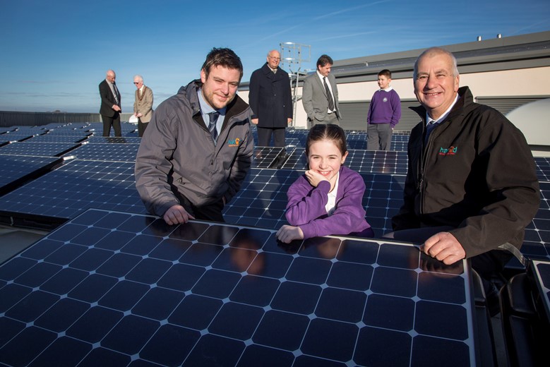 Hafod Renewables solar panels at the Holywell Superschool... Pictured are David and Richard  Jones of Hafod renewables with Ysgol Maes Y Felin  pupil Jessica Bailey on the roof  along with (From Left) Ysgol Treffynnon Headteacher Mr John Weir with Cllr Peter Curtis FCC , Cllr Chris Bithell Executive member education and youth FCC, Head Teacher of Ysgol Maes Y Felin Pete Davies and pupil Alan Birch.