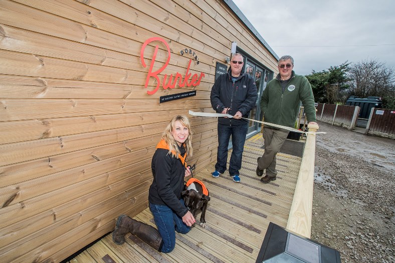 Official opening of North Clwyd Animal Rescue cafe , Doris's Bunker built by Rubicon. John Lyon from Rubicon with NCAR fund-raising manager Nicky Owens and David Davies.