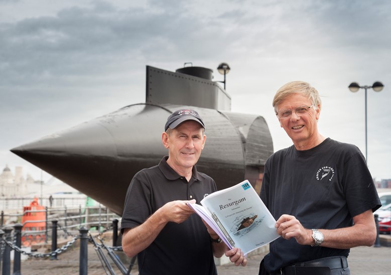 Chris Holden and fellow Chester scuba diver Dave Parry who are working to preserve the submarine wreck beneath the waves pictured close to the model at Woodside in Birkenhead
