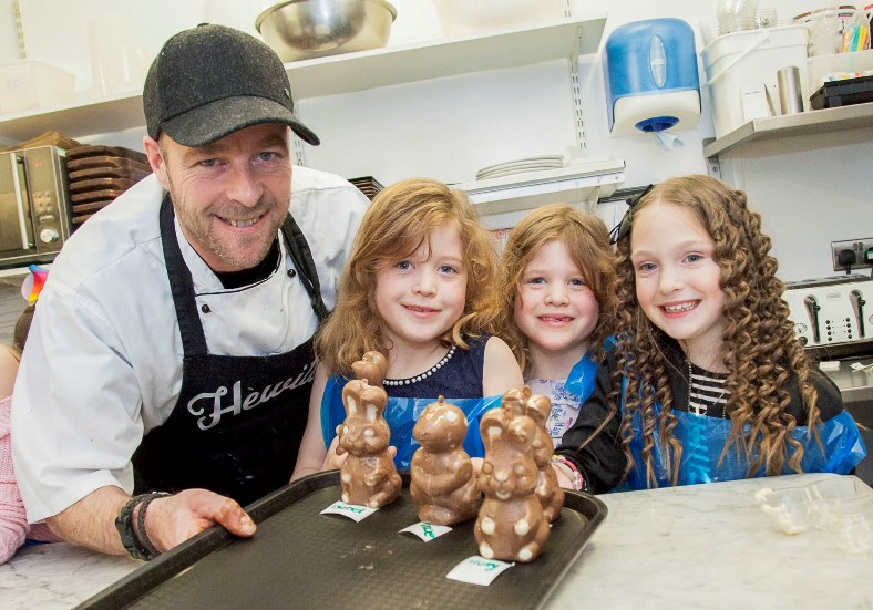 Hewitt's Cafe in Colwyn Bay hold chocolate themed events with choclatier and chef Stephen Hewitt running the workshops. Pictured: Stephen Hewitt in the workshop with Katie Evans, Connie Evans and Isabel Clifford