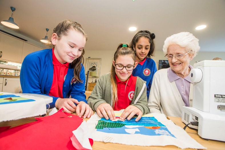 Artist Cefyn Burgess with school children from Ysgol Hendre working on the Patagonia project with residents at Bryn Seiont, Caernarfon residenst Daphne Egan with pupils, from left, Sian Williams, 11, Mia Gardner, 10 and Maryam Khan, 10.