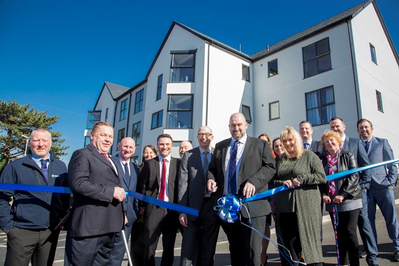 New Cartrefi Conwy housing development, Maes Glanarfon, Penmaenmawr Road, official opening by Carl Sargeant Cabinet Secretary for Communities and Children. Pictured is Cabinet Secretary Carl Sergeant cutting the ribbon with Gwynne Jones Operations manager Cartrefi Conwy and  residents William Lewis Legge and Jane Jones holding the ribbon.