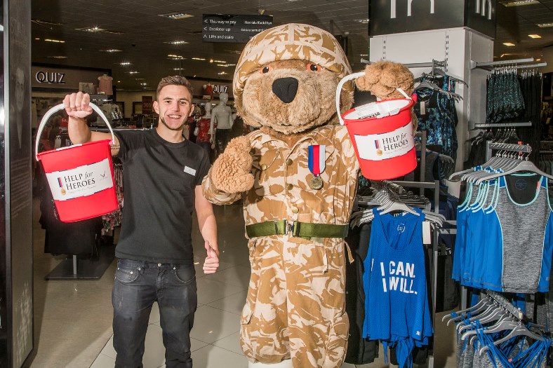 Debenhams at Eagles Meadow are raising funds for Help the Heroes and staff member Rhys Llloyd is pictured with the mascot