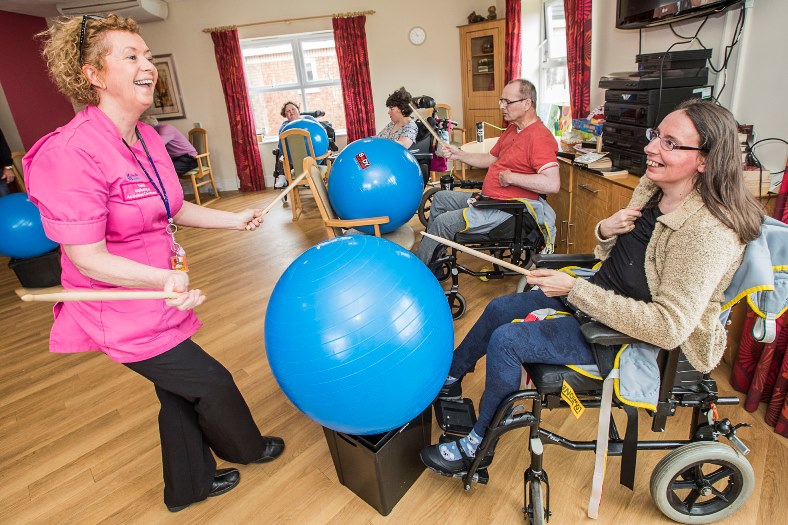 Pendine Park Enrichment team member Elaine Lee has found an entertaining way to keep residents for after seeing a video on YouTube inolving residents drumming to music. Elaine with resident Denise Drury