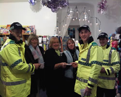Cadets handing out crime prevention leaflets to shopkeeper Wendy Jones of Crafty Needles and her customers