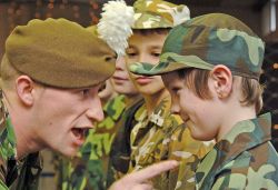 Corp Will Thomas of the Royal Welsh Second Battalion drills a young Neyland pupil