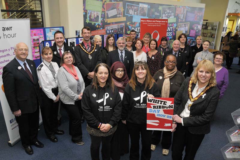 Councillors and officers from Flintshire County Council, staff from Wales and West Housing and staff from Coleg Cambria join together to show their support for White Ribbon Day