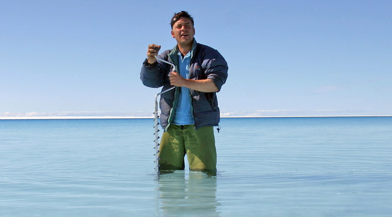 dr alun hubbard drilling into the ice below a lake in greenland