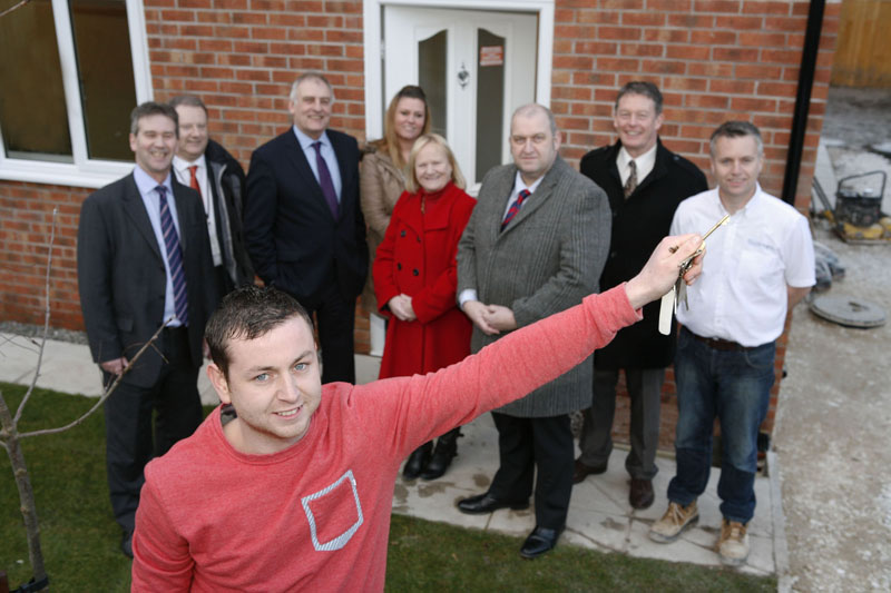 Jonny Carroll with the keys to his new family home in Greenfield with Carl Sargeant , centre; Wales Minister for Housing and Regeneration
