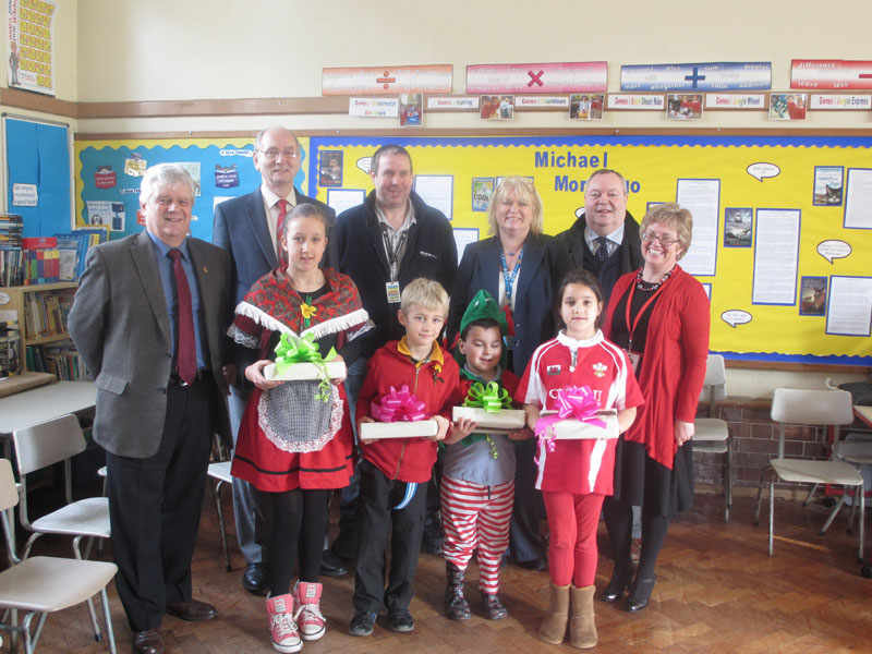 back row from left to right, John Cronin, community liaison for David Rees AM; Councillor Harry Bebell; Jonathan Henry, Amazon community support; Ceri Stephens, Amazon; John Slater, Community Liaison Officer for Dr Hywel Francis MP; and Crymlyn Primary head teacher Beverly Roberts