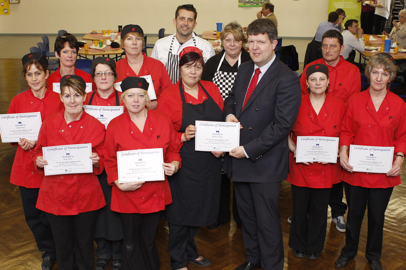 School cooks receiving certificates from Ian Budd, Director of Lifelong Learning at Flintshire County Council with Jeanette Orrey MBE