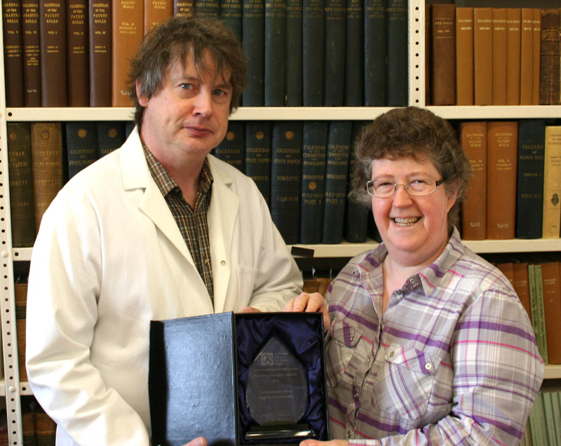 Pictured with the Marketing Innovation Award are Mark Allen, Conservator and Stephanie Hines, Archivist