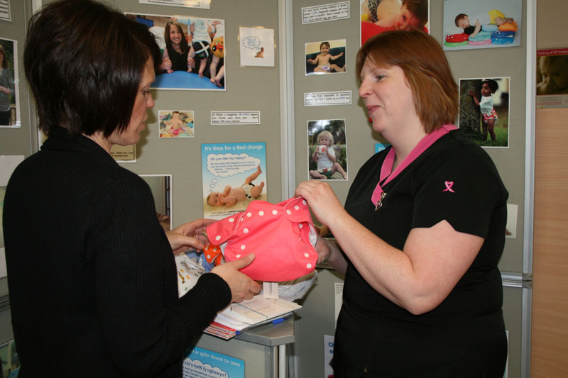Cath Cuss from CCBC Waste Management Team (Left) demonstrating the use of real nappies