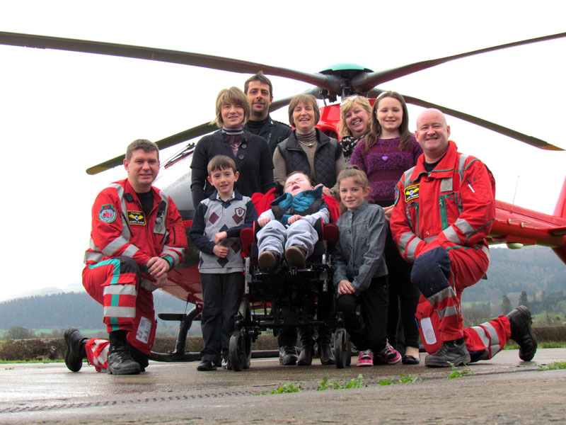 (front l-r) Paramedic Gareth Williams, Gwyn, Christopher and Emily Jerman, paramedic Rhodri Thomas. (back l-r) Rhian, pilot Capt James Benson, Michelle, WAA coordinator Lynne Hughes and Lucy Jerman