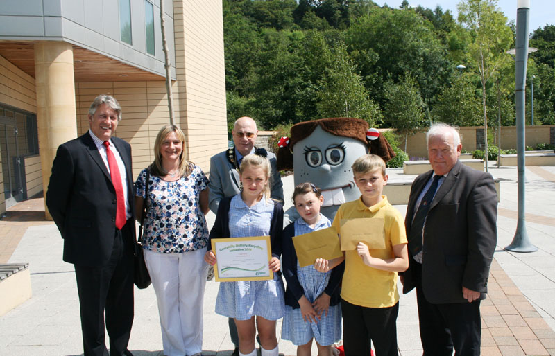 Fochriw Primary pupils Chianty Williams, Grace Jones and Brandon Evans are pictured with David Harding, Mrs Lisa Jones, Cllr David Carter, Bella the Battery and Cllr David Poole