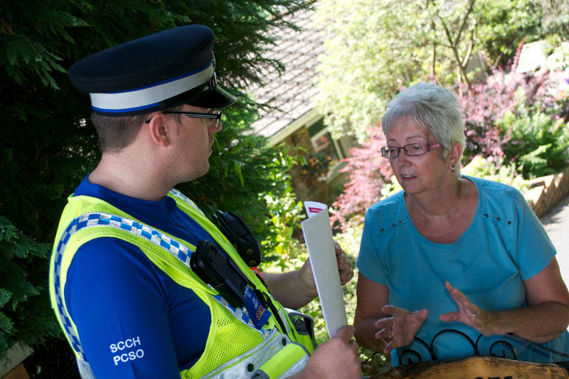 PCSO Gareth Handy speaks to Cwmaman resident Dorothy Williams