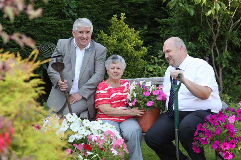 Grwp Cynefin CEO Walis George with Wales Housing Minister Carl Sargeant making sure everything in the garden's rosy for pensioner Edith