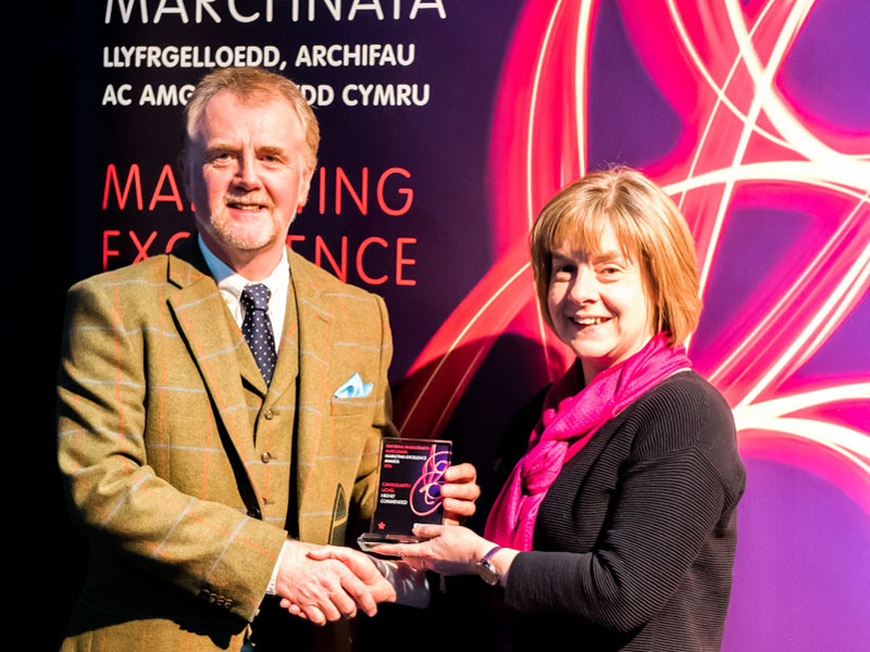 Bethan M Hughes of Denbighshire Libraries receiving the award from the judge Prof Jonathan Deacon