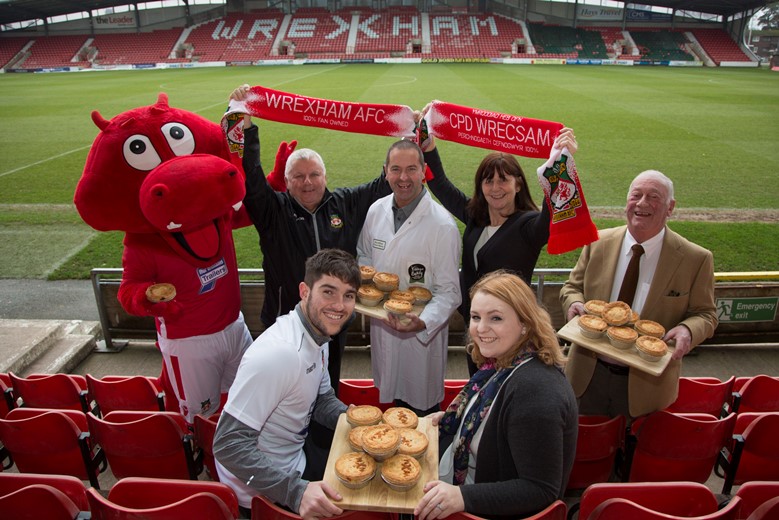 Village Bakery and the new Pie at WFC ....Pictured with Wrex the Mascot are front (L/R) are Robbie Evans WFC Player, Catherine Davies Village Bakery, Geoff Scott , commercial Manager WFC, Kerry Wilson , Village Bakery, Lesley Griffiths AM and Alan Jones Village Bakery Chairman.