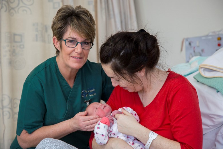 BCUHB... Pictured is Julie Edwards, a maternity support worker at Wrexham Maelor hospital who is up for a Royal College of Nursing national award for her work pictured with Nicola Griffiths and baby Alice , 36 hours old.