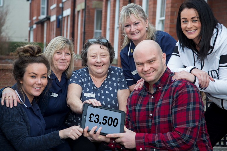 Coed Mor Care Home in Abergele Pictured is Gareth Price, who has raised £3,500 for Ipads, TVs and portable DVD players for the cancer unit at Glan Clwyd Hospital, Photographed with staff from Coed Mor Care Home Leanne Jones, Mandy Gill, Sue Davies , Gail Price (Gareths Mum) and Gareths Partner Bianca Baylis.
