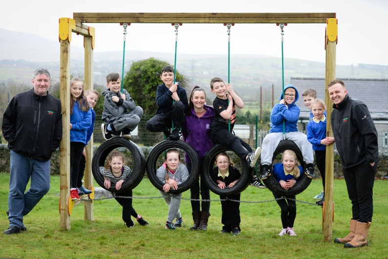 Children from Ysgol Bro Lleu, Penygroes, Caernarfon enjoy the new play equipment installed by Creative Play which was paid for with a grant from Tesco 5p bag scheme.